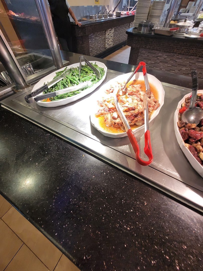 Buffet trays with Chinese dishes and sushi.