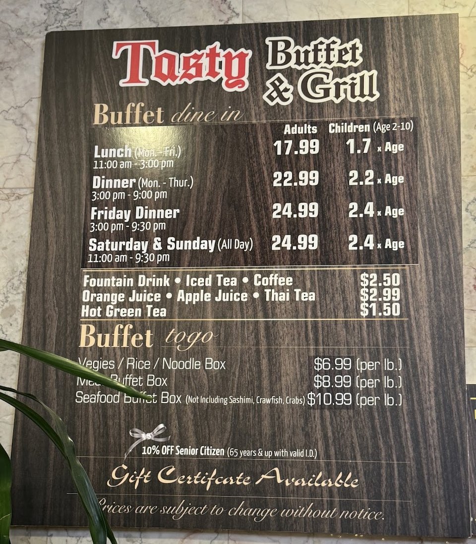 Printed menu beside buffet-style dishes.